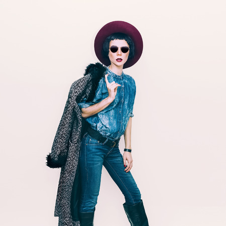 Glamorous fashion model in coat and stylish jeans clothes. Fashionable autumn Lookの写真素材