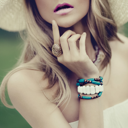 Sensual romantic lady in the park on a walk. Summer fashion accessories.