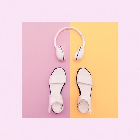 Fashion white sandals and headphones on vanilla background. Urban summer timeの写真素材