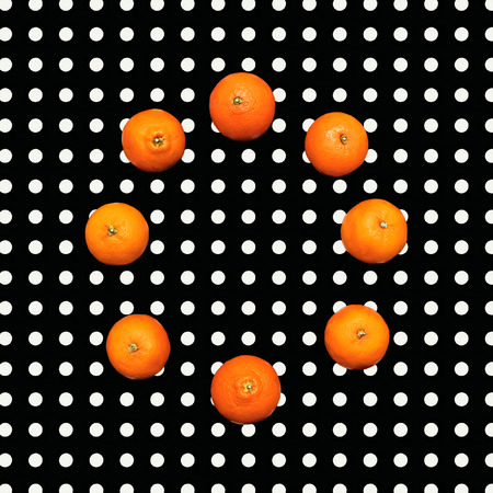 Mandarin orange on polka dots backgroundの写真素材