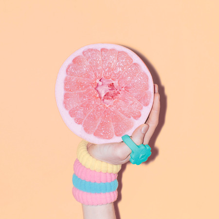 Hand and grapefruit, vanilla accessories, fashion style, minimal