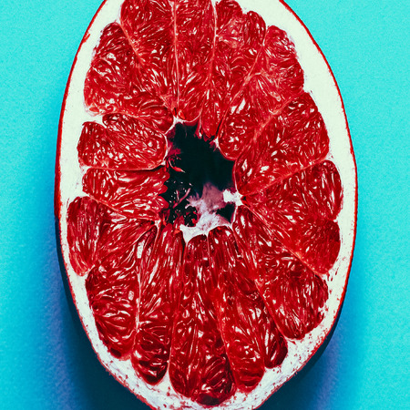 Juicy grapefruit on blue background. fashion photoの写真素材