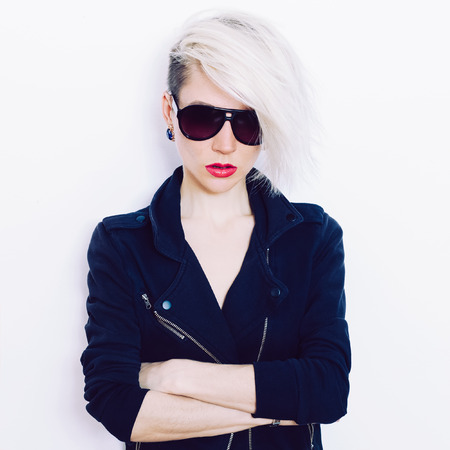 Blonde girl with trendy hairstyle and fashion sunglassesの写真素材