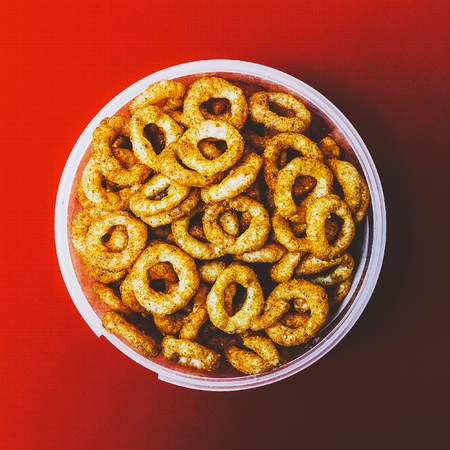 Bucket chips on red background. Minimalism style