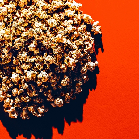 Golden Popcorn on red background. Minimalism styleの写真素材