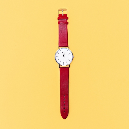 Red clock on yellow background. Minimalism design