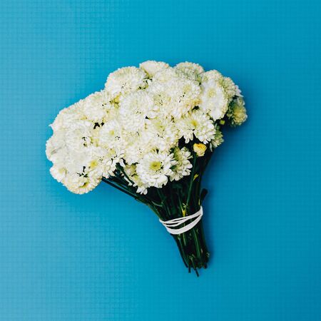 White Bouquet on blue background. Fashion. Minimalism. detailsの写真素材
