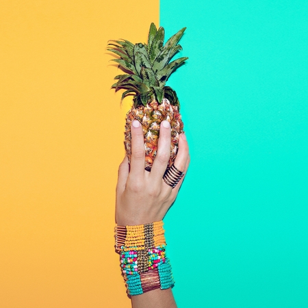 Bright stylish bracelets and Pineapple. Go to the beach. Tropical fashion mix.の写真素材