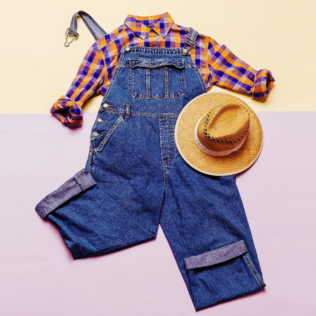 Fashionable denim overalls. Stylish clothes. Minimal Country fashion plaid shirt and hatの写真素材