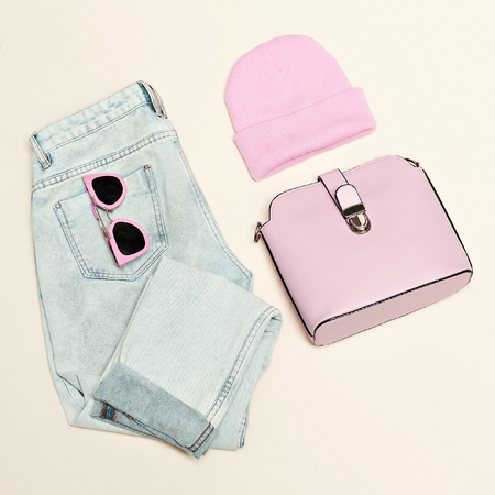 Fashion woman accessories set. Glamor stylish bag, jeans, sunglasses. Elegant trendy girl. Unusual creative look. Vanilla pastel background, Vanilla outfitの写真素材
