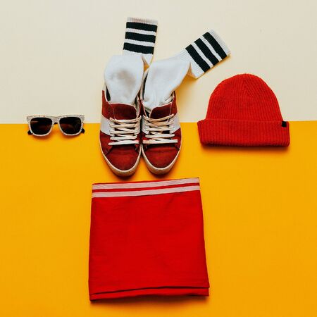 Urban Style Clothing. Skateboard fashion outfit. Sneakers, stockings, hat. Focus on redの写真素材