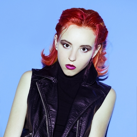 Model Glam Rock style. Red hair and trend Leather Jacket