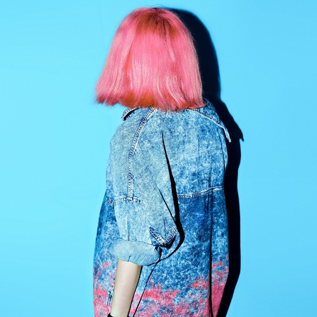 Girl with pink hair and denim clothing. Stylish lookの写真素材
