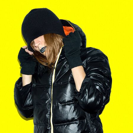 Swag sexy Model in black down jacket stylish hipster trash urban style makeup trend Beanie and glovesの写真素材