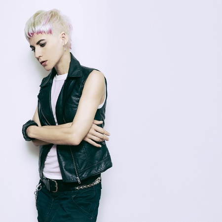 Blonde with a fashionable hairstyle and stylish clothes. Rock fashion styleの写真素材