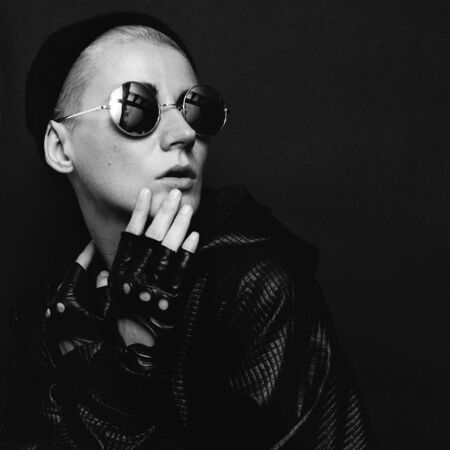 stylish model in black autumn winter trend accessories gloves and glasses