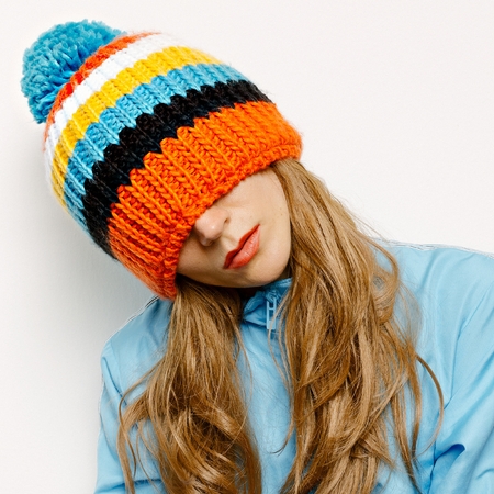 Stylish Brunette in a Hat with pompon and a blue jacket Snowboard Fashionの写真素材