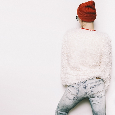 Hipster Girl Urban Swag. Autumn outfit. Beanie Hat. Stylish white coat. Fashion conceptの写真素材