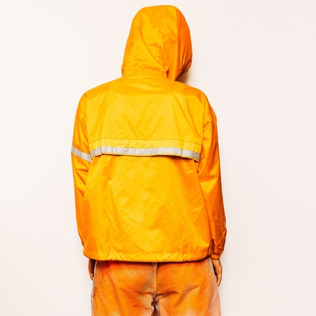 Trendy Urban Outfit Tomboy model in a bright orange sports fashion clothing Snowboardの写真素材