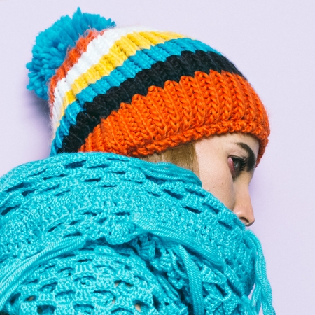 Girl Pom pom hat and knitted scarf. Warm fashion accessoriesの写真素材