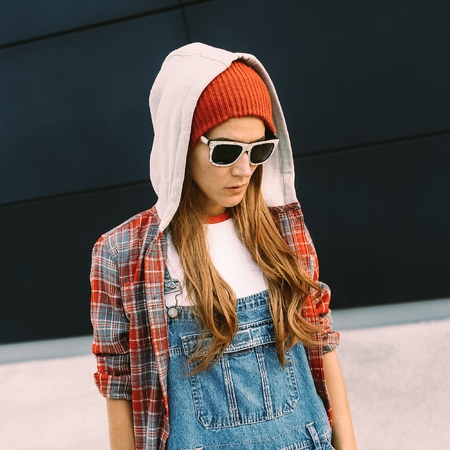 Stylish Girl Student. Autumn urbanDenim overalls and red accessories.の写真素材