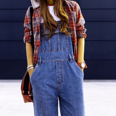 Girl student. In fashionable denim overalls. Urban Styleの写真素材