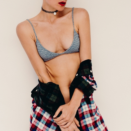Casual fashion style Model. Bra and checkered shirt. Sensual accessory around the neck Chokerの写真素材