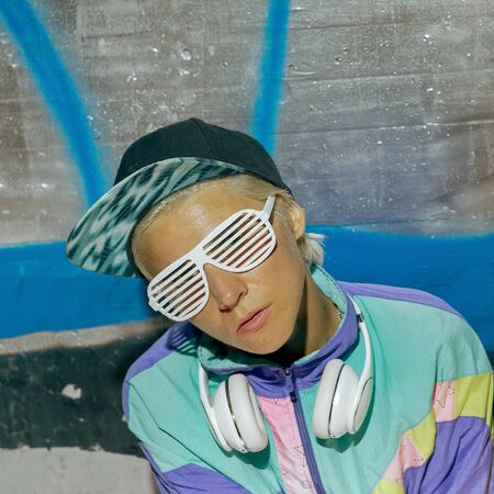 DJ girl in the night city location. Street fashion Swag