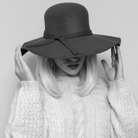 Lady in fashionable hat. Stylish accessories of the season