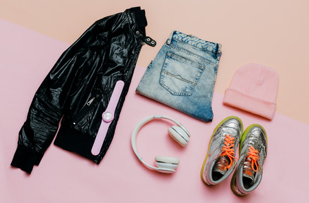 Fashion Outfit for a girl. Stylish black clothes and bright accessories. Sports Urban. Minimal. Headphones and Sneakers Active Street Lifeの写真素材
