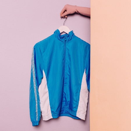 Stylish sportswear. Minimal fashion. Blue jacket on a hanger. Wardrobe trendsの写真素材