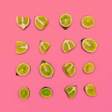 Limes on a pink background. Minimal idea food creativeの写真素材