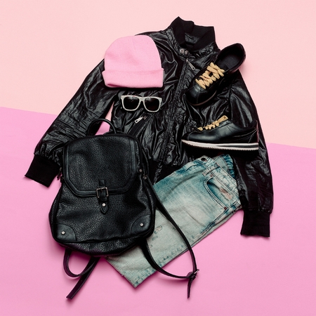 Hipster Urban Outfit girl. Stylish black clothes and bright accessories. Stylish backpack and beanieの写真素材