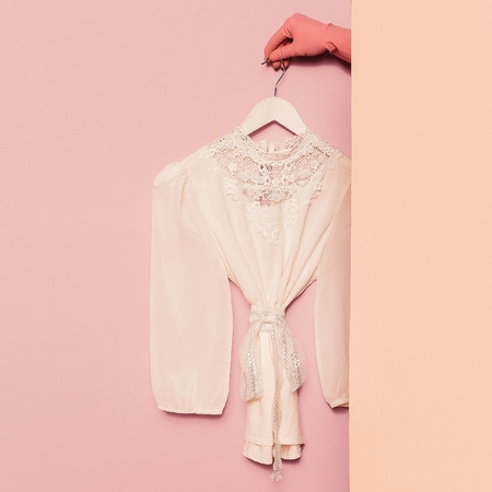 Stylish clothes. Romantic fashion. White shirt lace vintage on the hanger. Wardrobe trendsの写真素材