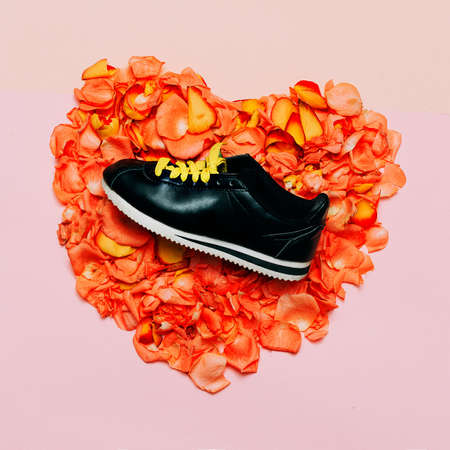 Minimal creative design. Glamorous shoes flowers background. Spring is comingの写真素材