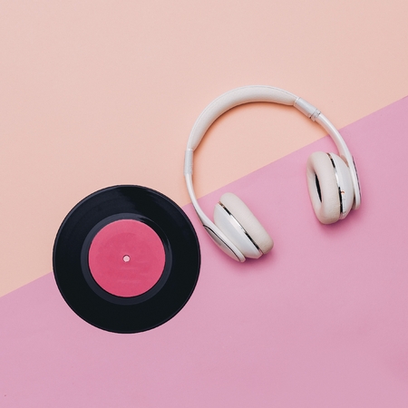 Minimal creative art. Musical retro vibrations. Headphones and vinyl. Top viewの写真素材