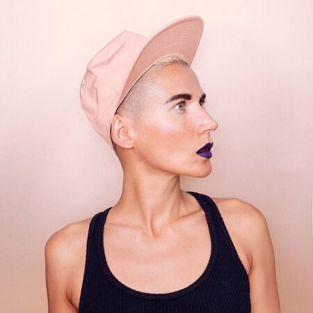 Girl in a stylish cap. Urban Tomboy Style Fashionの写真素材