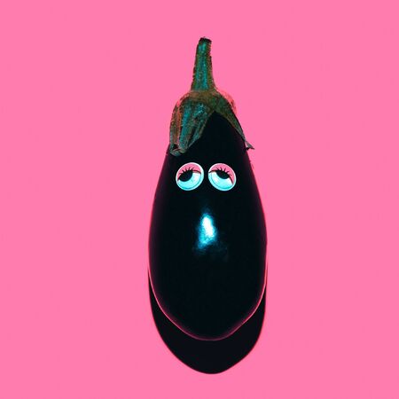 Eggplant with funny sad eyes. Vegan minimal styleの写真素材