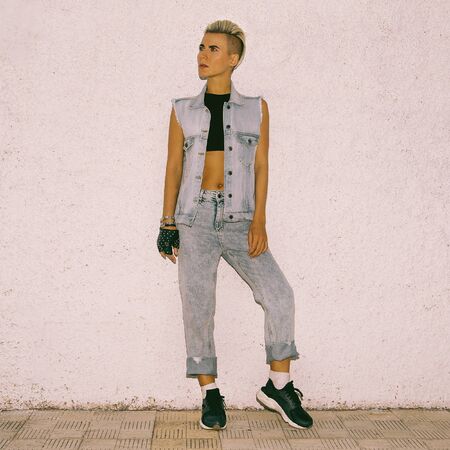 Fashion blonde with short haircut in jeans clothes in the cityの写真素材