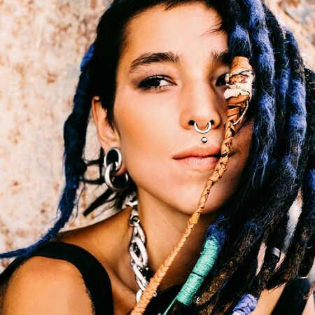 Teen spanish girl with trendy dreadlocks and piercings. Outdoorの写真素材