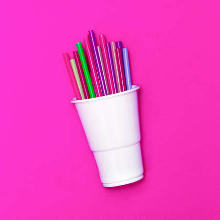 Plastic tableware. Minimal. Glass and tubes for cocktailの写真素材