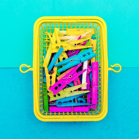 Multicolored clothespins in a basket. Minimal art styleの写真素材