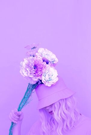 Sensual summer girl with flowers in trendy bucket hat. Purple aesthetic designの写真素材