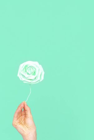 Plastik flowers aesthetic on blue background. Minimal aqua menthe trendsの写真素材