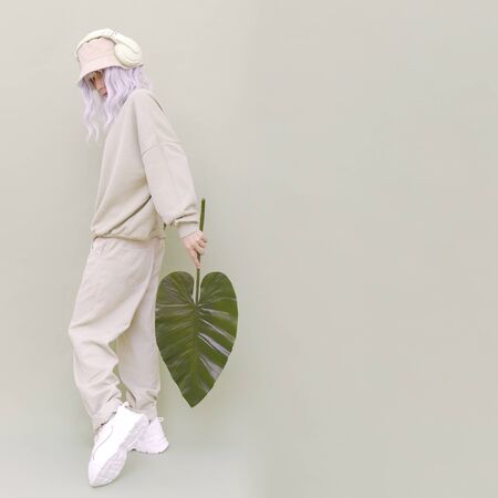 Dj Girl posing in studio. Urban style. Hip-hop. Dancer. Fresh casual beige outfit. Fashion...
