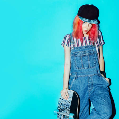 Pretty Teenage skate girl with pink hair Urban Style Jeans Fashionの写真素材