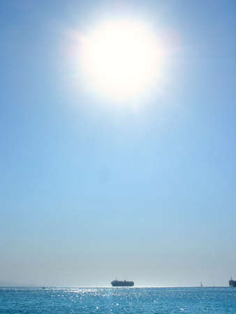 bright sun over the Red sea with shipの写真素材