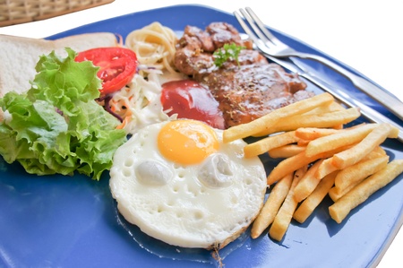 Steak , salad, pasta and eggs breakfast on isolate backgroudの写真素材