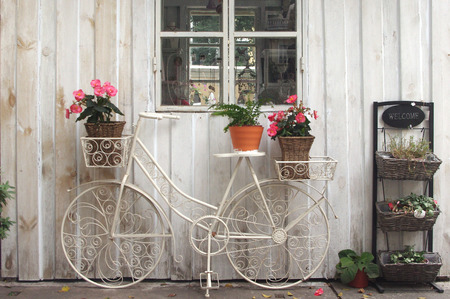 vintage bicycle on vintage white wooden house wallの写真素材