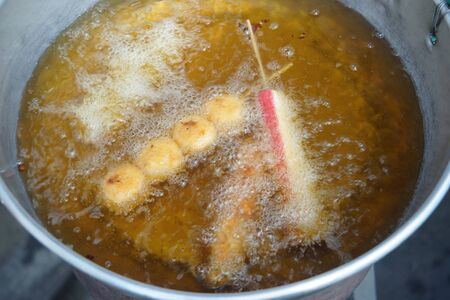 thai meat balls deep frying in oil at street market